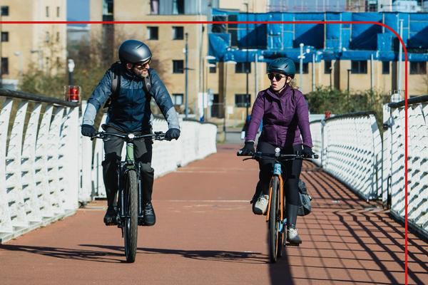 Two people riding e-bikes